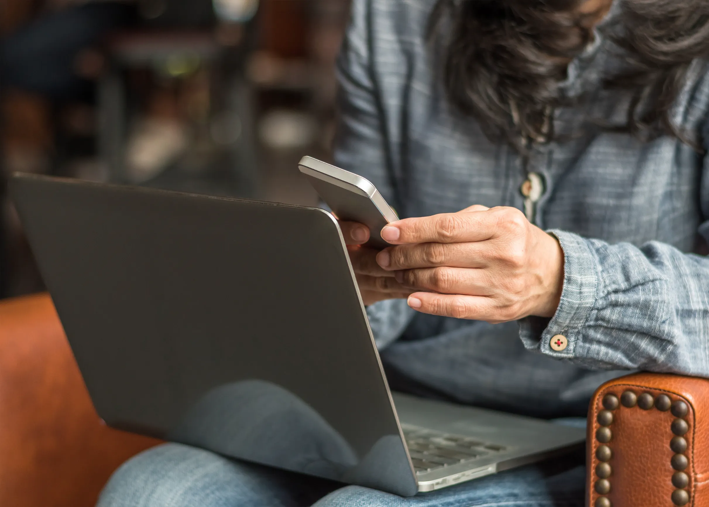 Person on phone and laptop