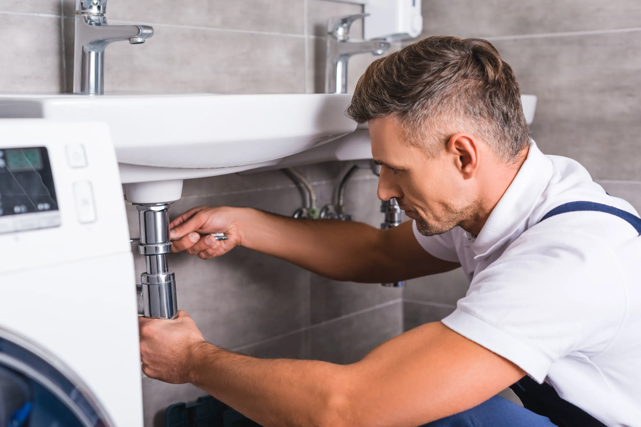 Plumber working on sink