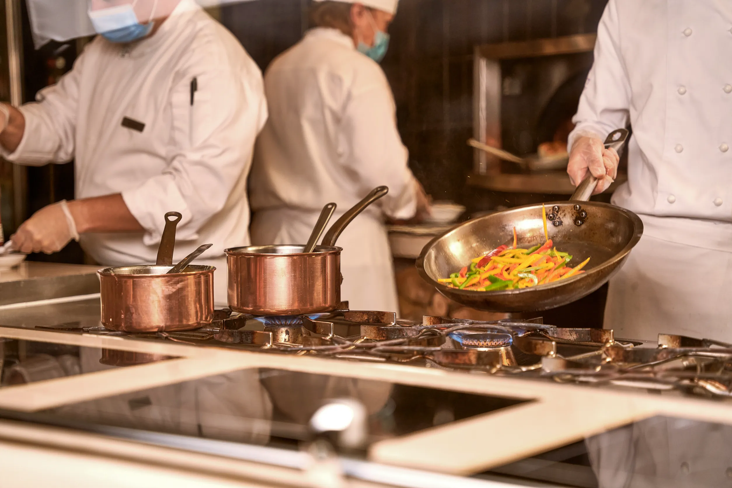 Restaurant kitchen with chefs cooking