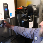 plumber flushing a tankless water heater