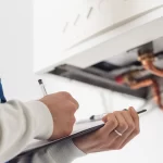 plumber checking requirements for a tankless water heater
