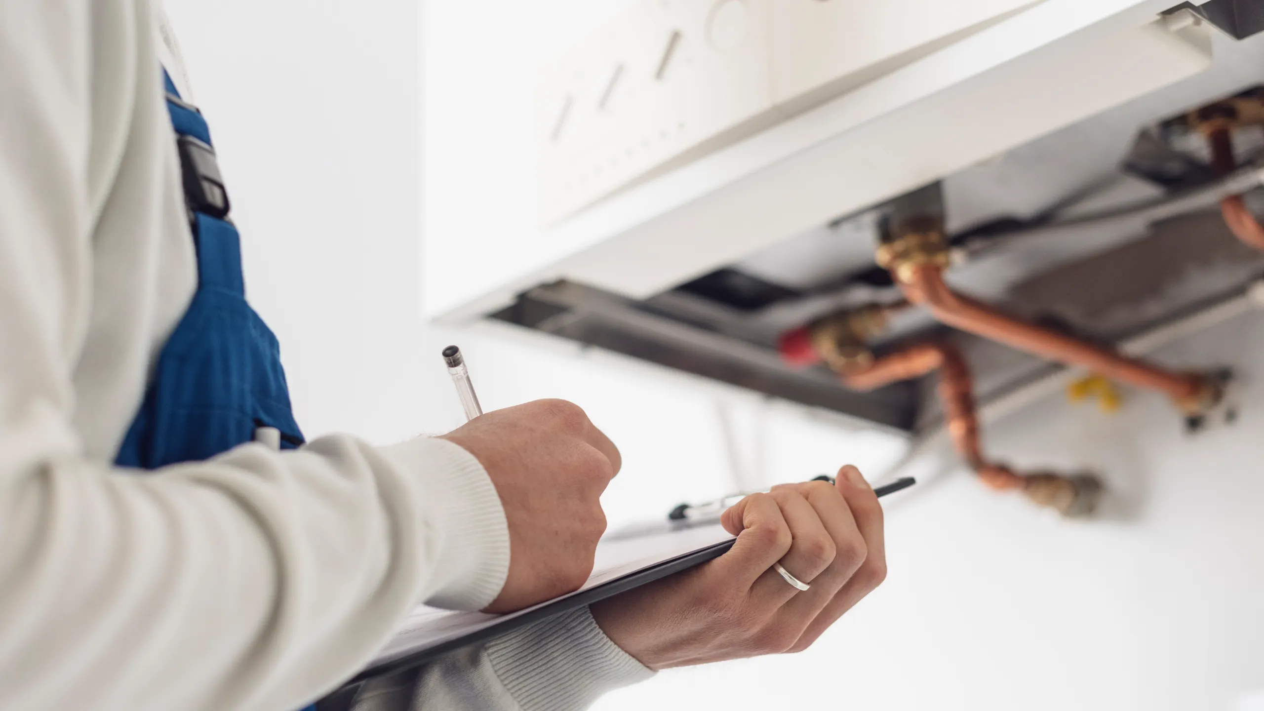 plumber checking requirements for a tankless water heater