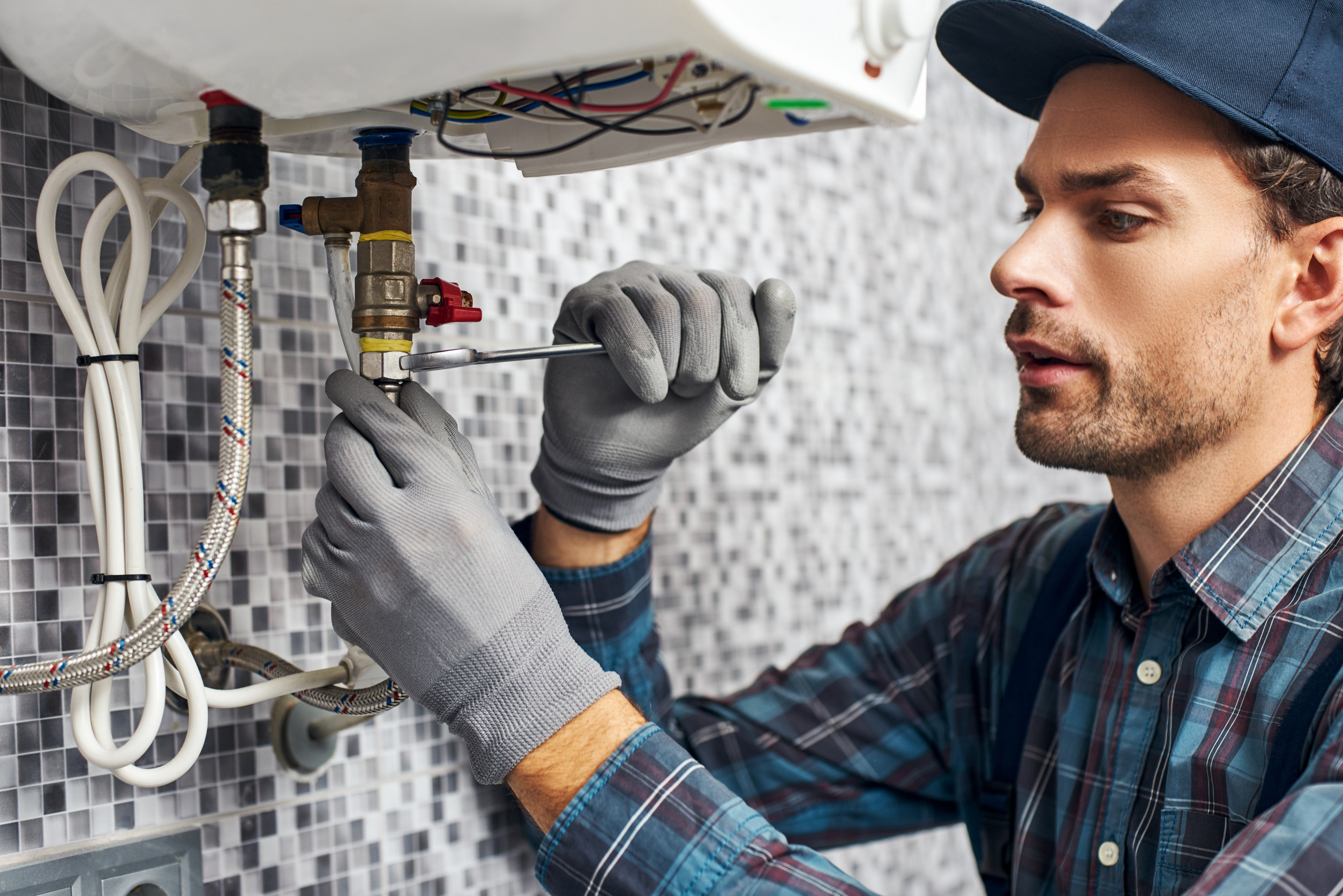 Plumbing professional working on a tankless water heater