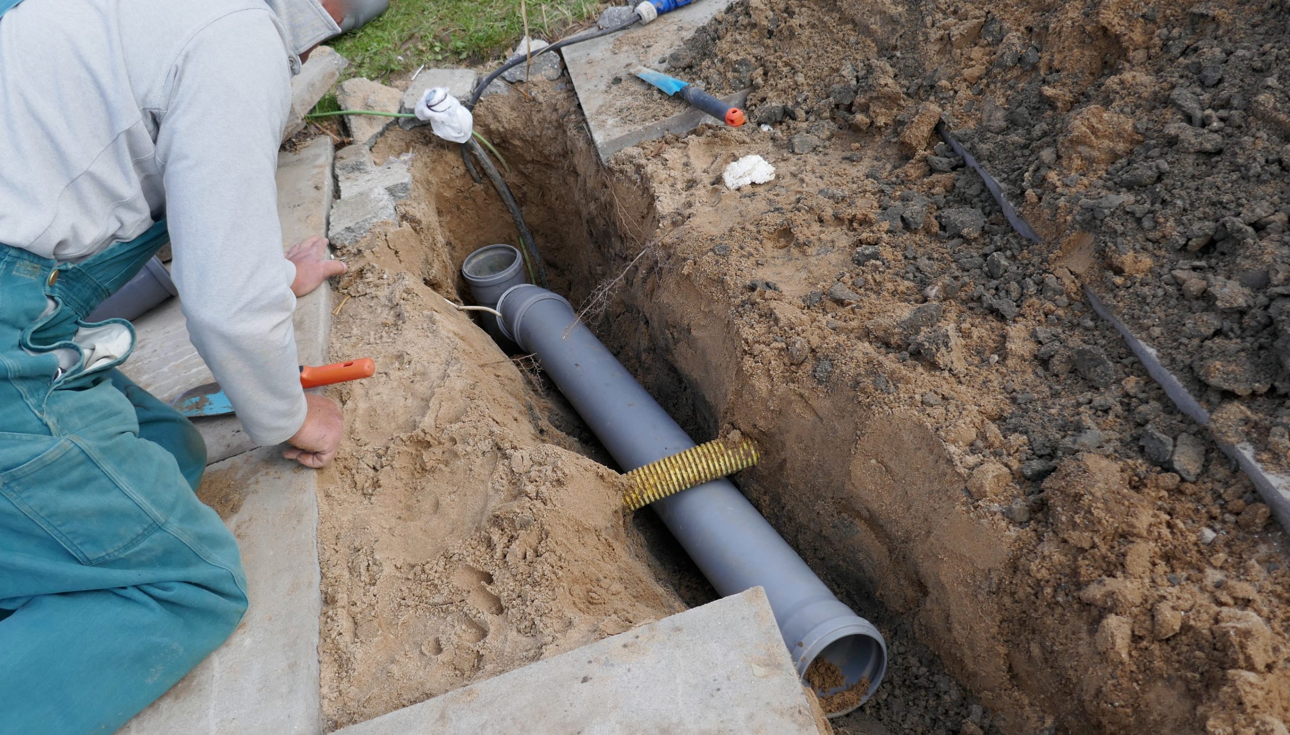 Plumbing professional working on sewer pipe
