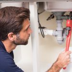 Plumber working on sink