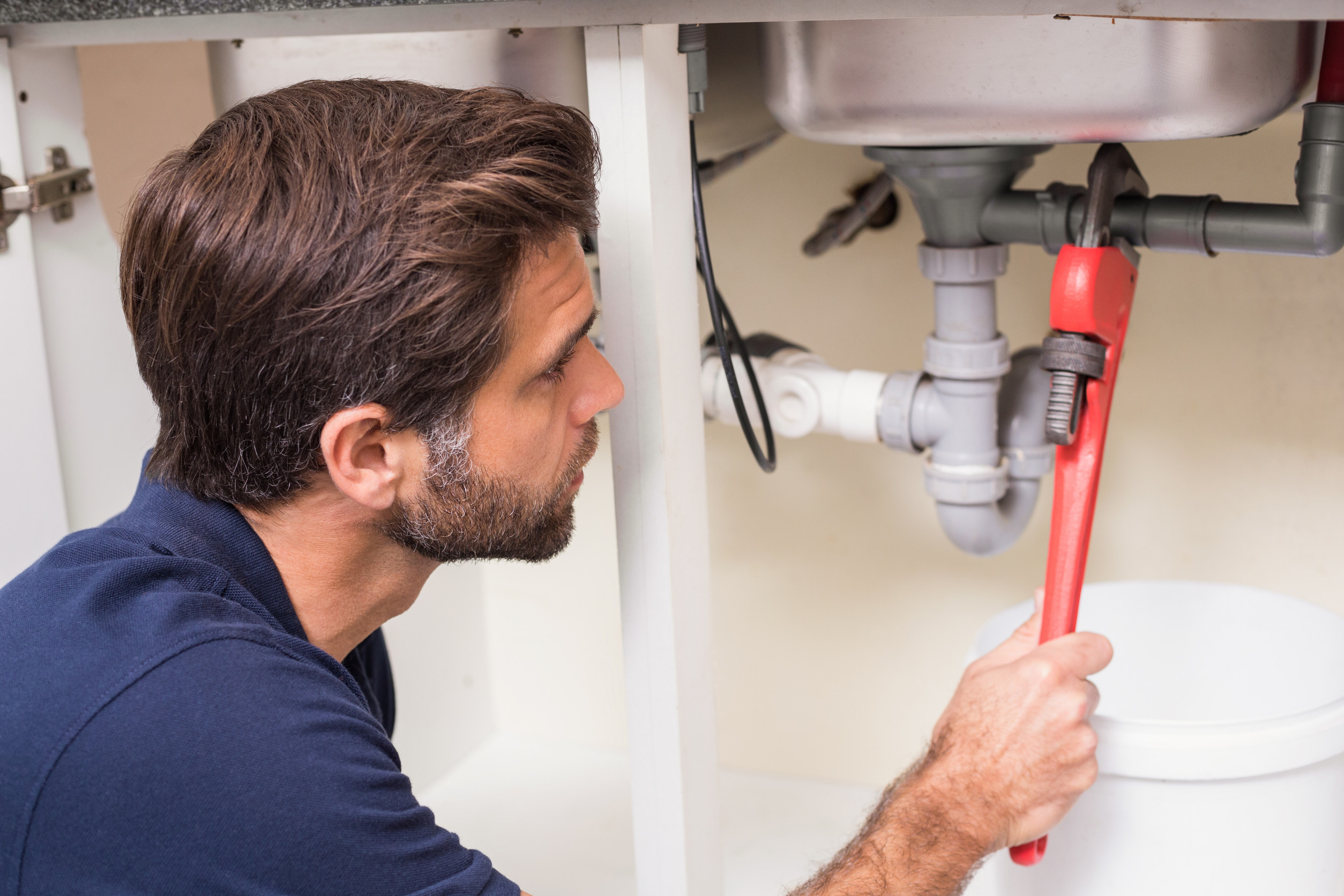 Plumber working on sink